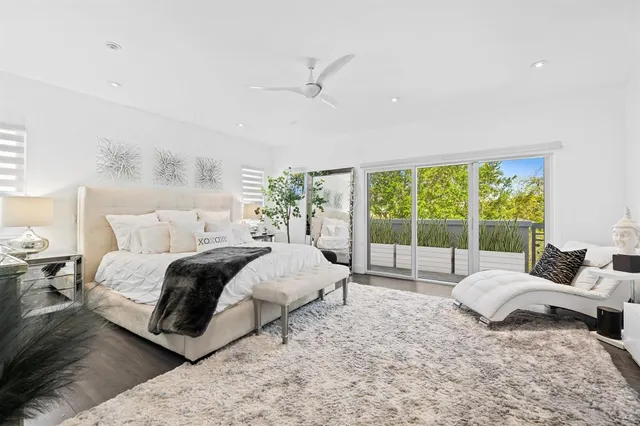 a bedroom with a large bed and a large window