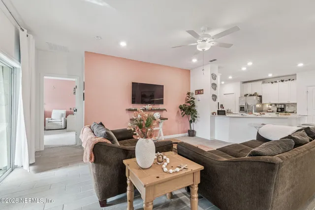 a spacious bedroom with a bed and a chandelier
