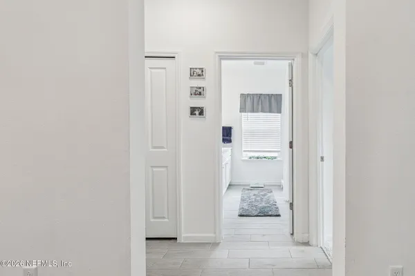 a living room with furniture a piano and a flat screen tv