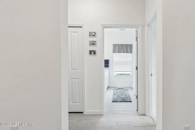 a living room with furniture a piano and a flat screen tv