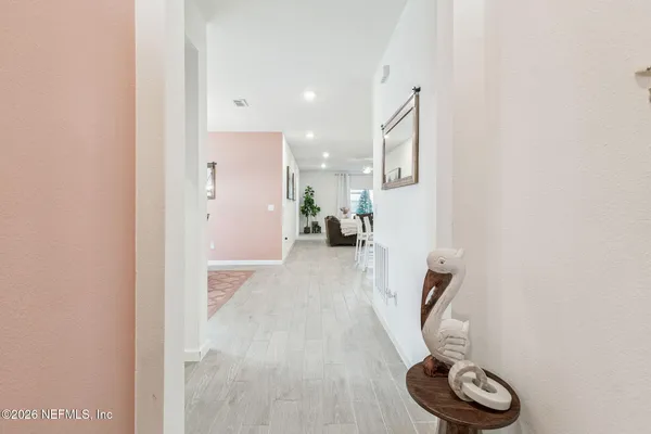 a view of a dining room with furniture and chandelier
