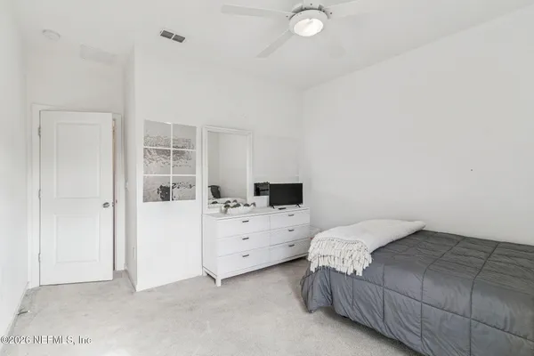 a kitchen with a stove and a view of living room