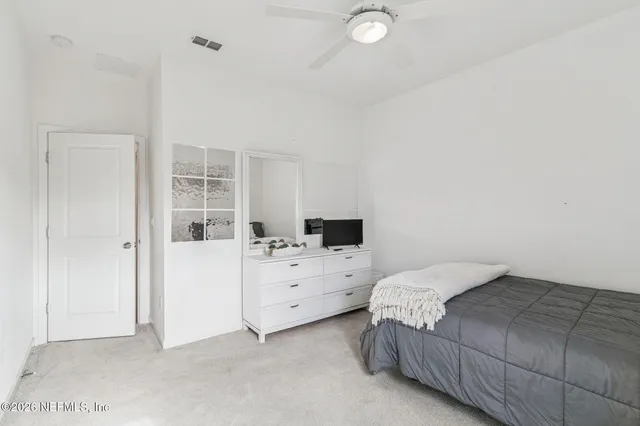 a kitchen with a stove and a view of living room