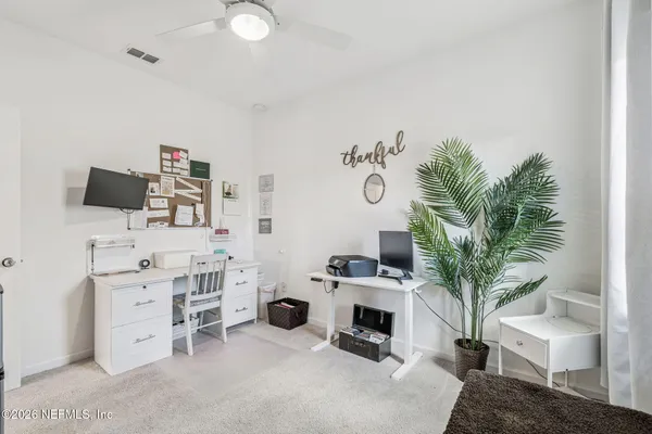 a sign board with a play ground in the back yard