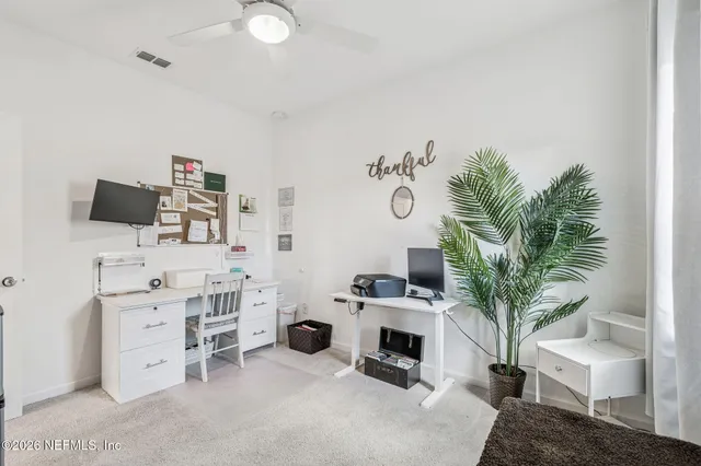 a sign board with a play ground in the back yard
