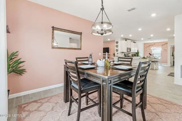 a view of a dining room with furniture and window