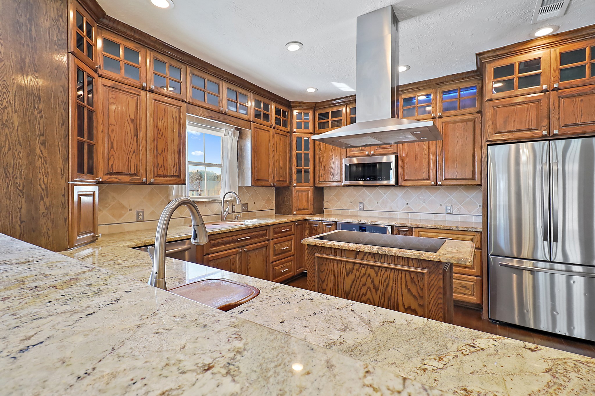 1306 Spring Branch Drive Baytown, TX 77523 - Photo 34 of 38 a kitchen with stainless steel appliances granite countertop a sink stove and refrigerator