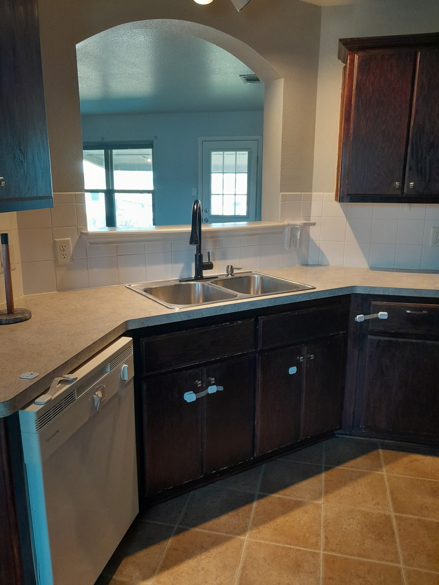 1309 Marlee Circle Copperas Cove, TX 76522 - Photo 3 of 16 Kitchen featuring dark tile patterned floors, white dishwasher, light countertops, and tasteful backsplash