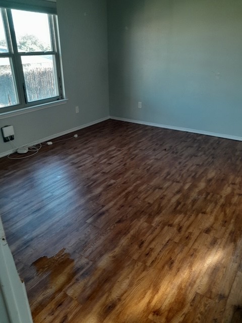 1309 Marlee Circle Copperas Cove, TX 76522 - Photo 7 of 16 Empty room with dark wood-style flooring