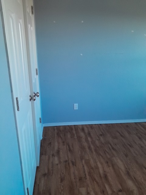 1309 Marlee Circle Copperas Cove, TX 76522 - Photo 10 of 16 Unfurnished room featuring dark wood-style flooring and baseboards