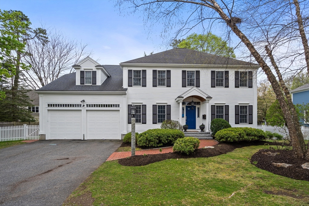 26 Thomas Road Wellesley, MA 02482 - Photo 1 of 1 a front view of a house with a yard and garage