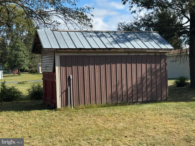 a view of a backyard with wooden fence