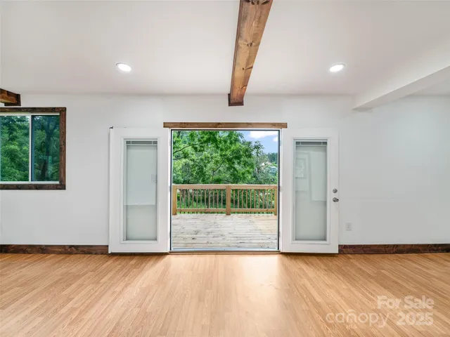 a view of a livingroom with wooden floor and window