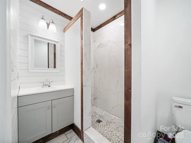a bathroom with a shower sink and mirror