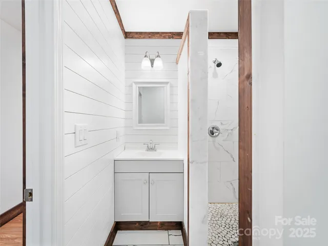 a bathroom with a shower and a sink