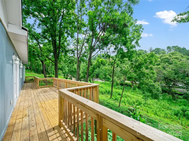 a view of balcony with deck and yard