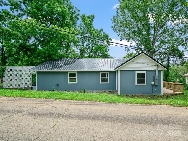 a front view of house with yard and trees