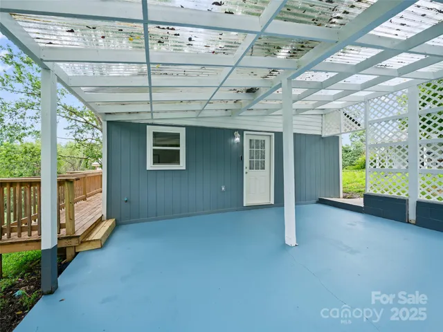 a view of a porch with a table and chairs