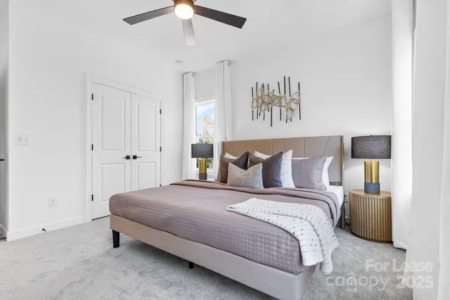 a bedroom with a bed and a night stand