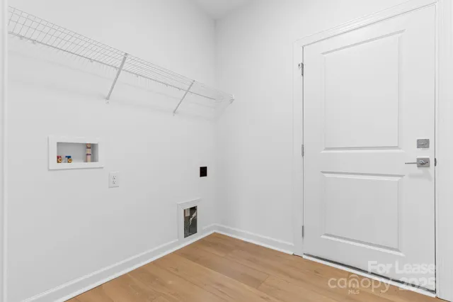 a view of a room with wooden floor