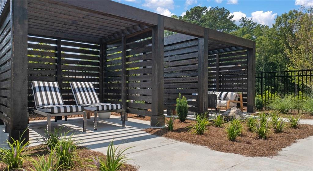 100 Rosemoore Drive Covington, GA 30014 - Photo 30 of 41 a view of a patio with table and chairs with wooden floor and fence