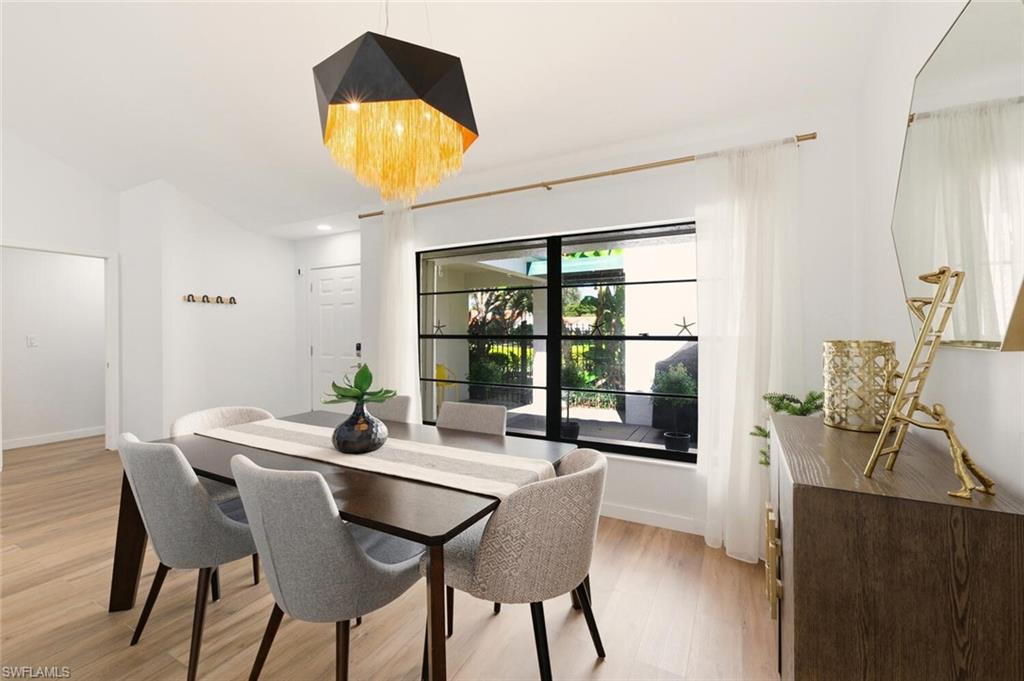 772 Reef Point Circle Naples, FL 34108 - Photo 11 of 46 a view of a dining room with furniture and window