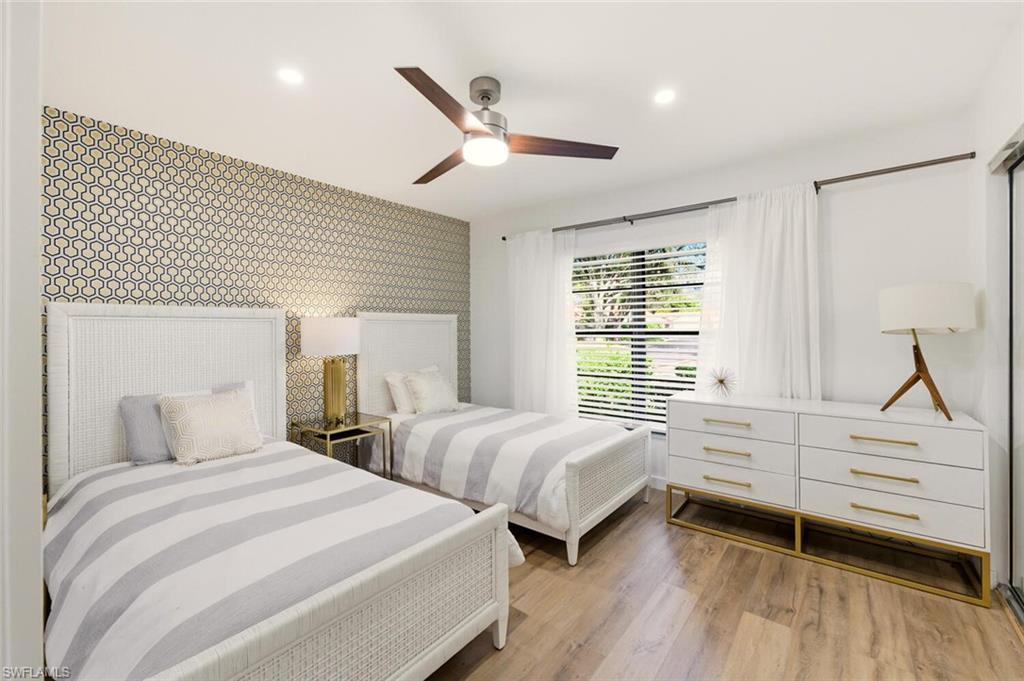 772 Reef Point Circle Naples, FL 34108 - Photo 21 of 46 a bedroom with two beds and a window