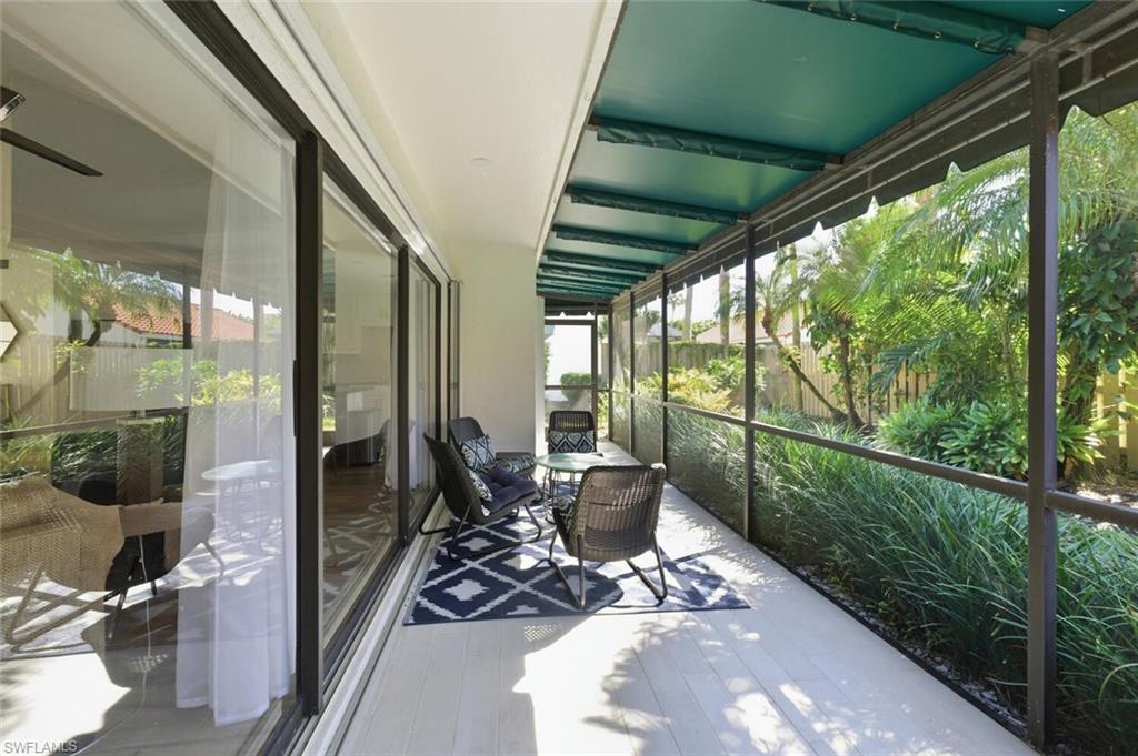 772 Reef Point Circle Naples, FL 34108 - Photo 22 of 46 a view of a porch with chairs and backyard