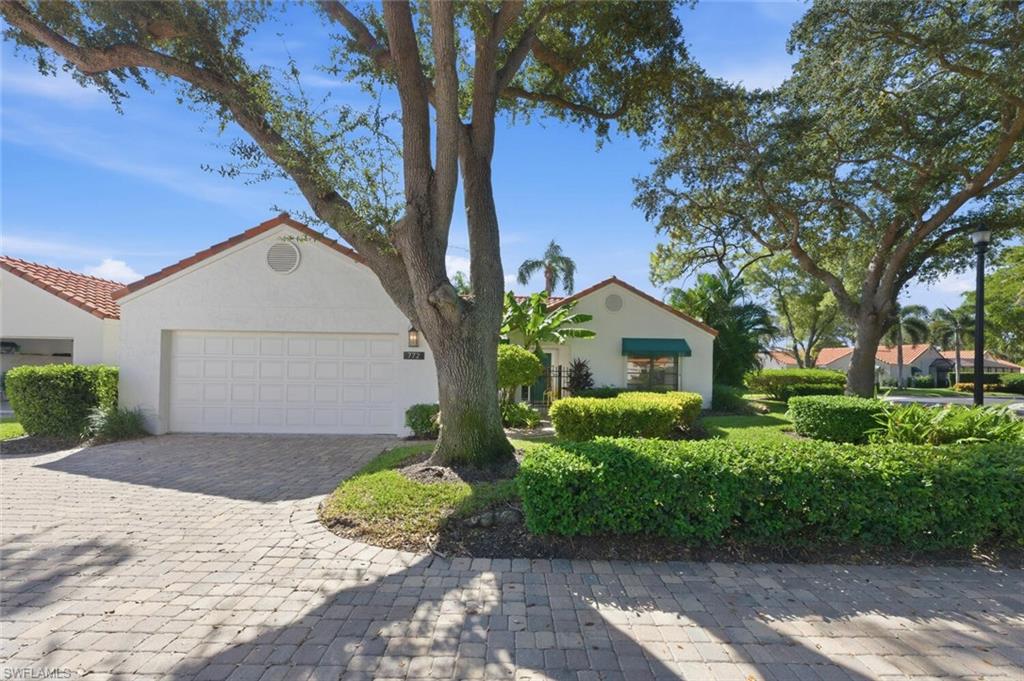 772 Reef Point Circle Naples, FL 34108 - Photo 28 of 46 a front view of a house with garden