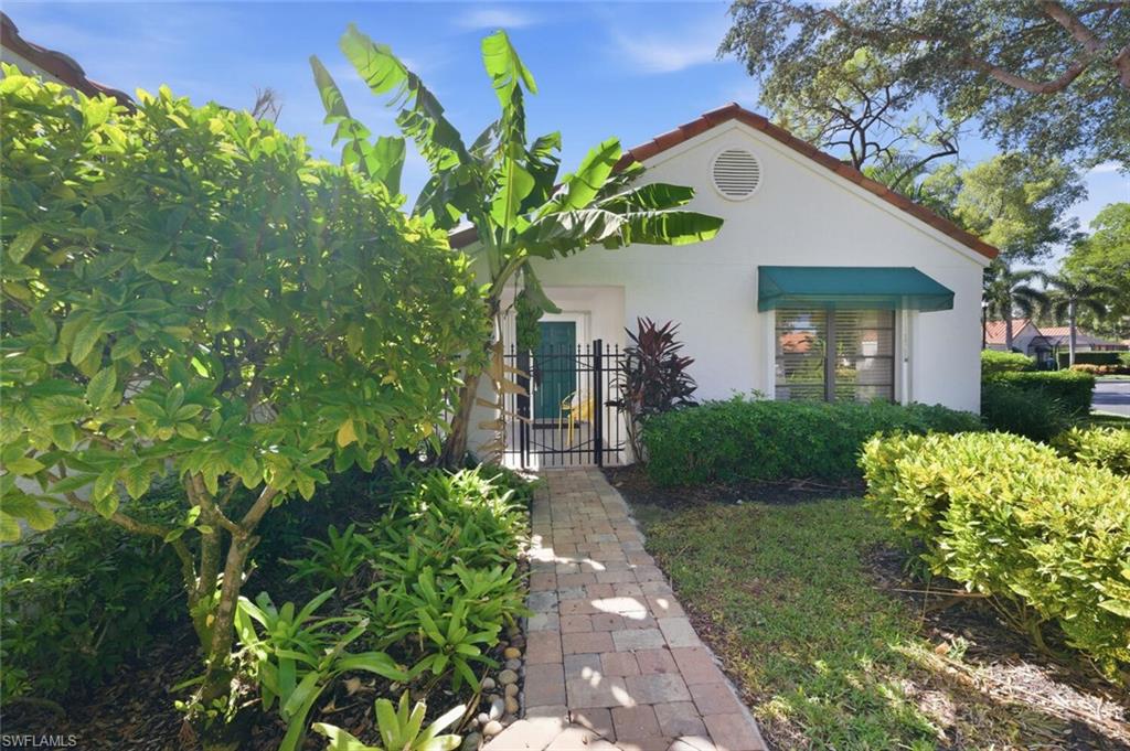 772 Reef Point Circle Naples, FL 34108 - Photo 29 of 46 a front view of a house with a yard