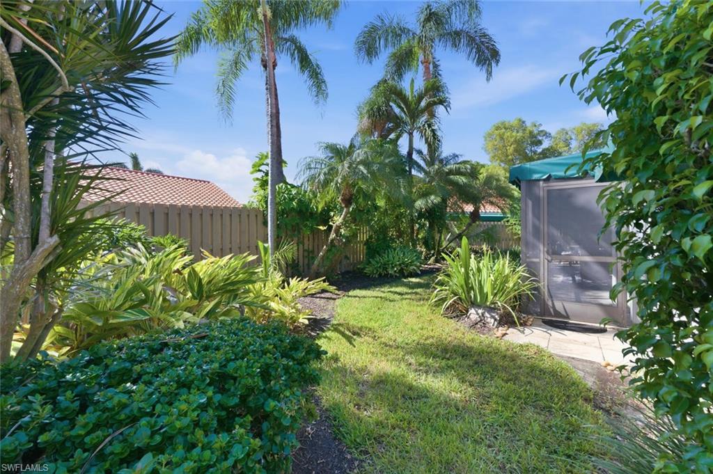 772 Reef Point Circle Naples, FL 34108 - Photo 34 of 46 a view of a garden with a fountain