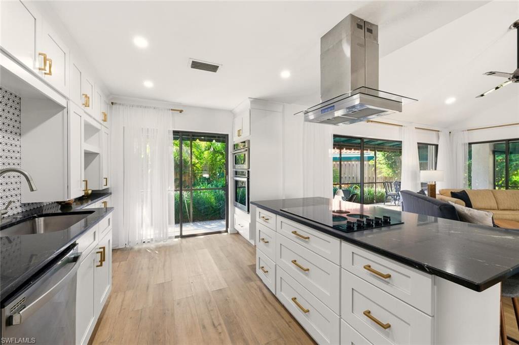 772 Reef Point Circle Naples, FL 34108 - Photo 4 of 46 a kitchen with granite countertop stainless steel appliances a sink and counter space