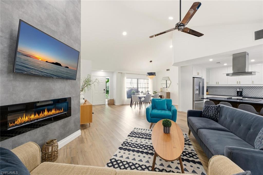 772 Reef Point Circle Naples, FL 34108 - Photo 9 of 46 a living room with furniture and a fireplace
