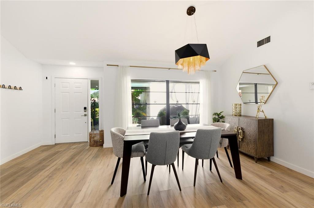772 Reef Point Circle Naples, FL 34108 - Photo 10 of 46 a view of a dining room with furniture window and wooden floor