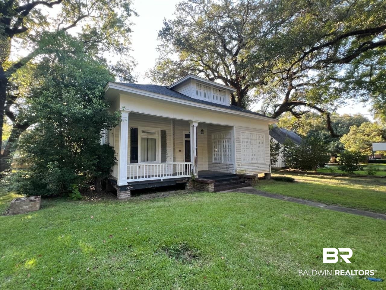 104 Mohawk Street Mobile, AL 36606 - Photo 2 of 12 Bungalow-style home featuring covered porch and a front yard