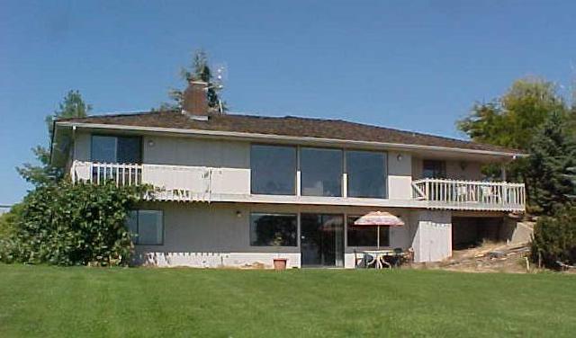 a front view of a house with a garden and plants