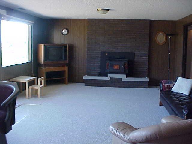 14208 Fisk Road Yakima, WA 98908 - Photo 7 of 9 a living room with furniture and a fireplace