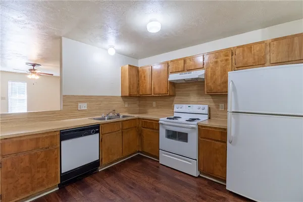 a kitchen with a white cabinets stove and refrigerator