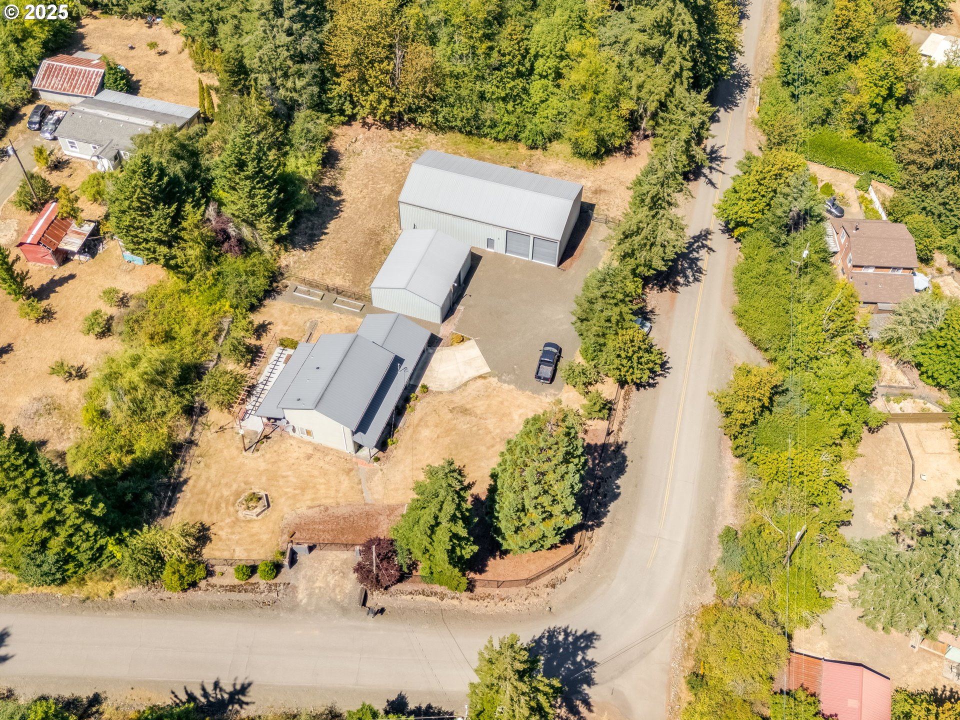 7575 Birch Street Grand Ronde, OR 97347 - Photo 44 of 48 an aerial view of a house with a yard and garden in the background