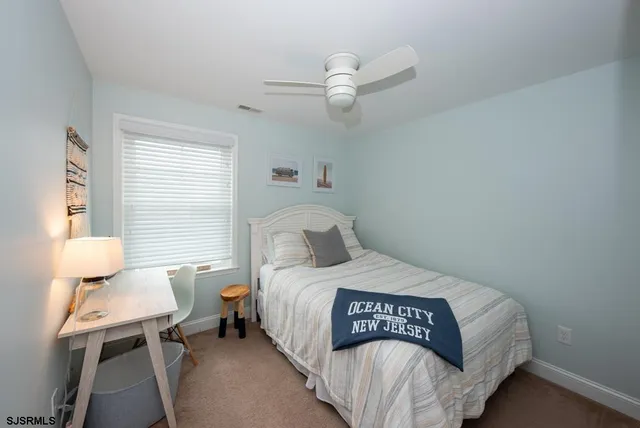 a bedroom with a bed and a table in it