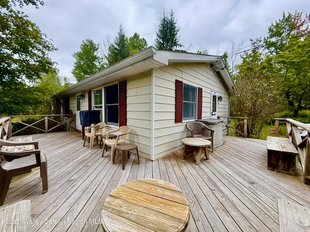 a front view of house with yard and trees in the background