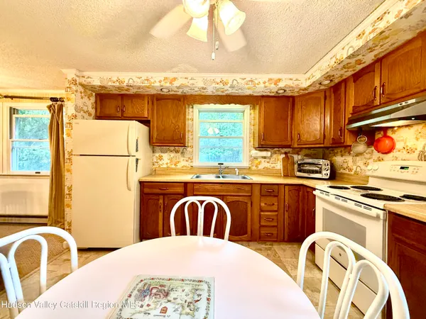 a kitchen with stainless steel appliances granite countertop a sink a stove and refrigerator