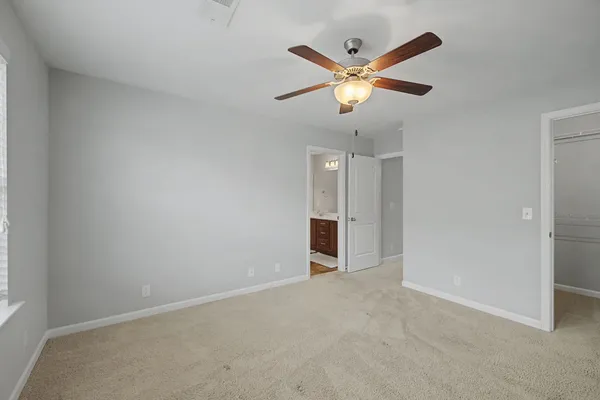 an empty room with closet and fan