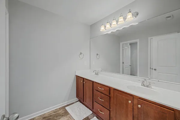 a bathroom with a double vanity sink and a mirror
