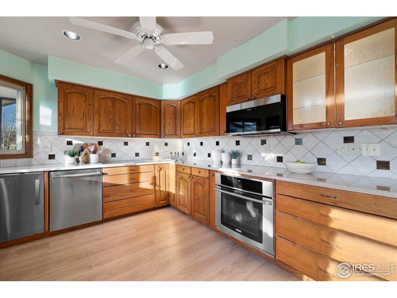 2713 Beech Way Longmont, CO 80503 - Photo 14 of 36 a kitchen with granite countertop cabinets stainless steel appliances and a sink
