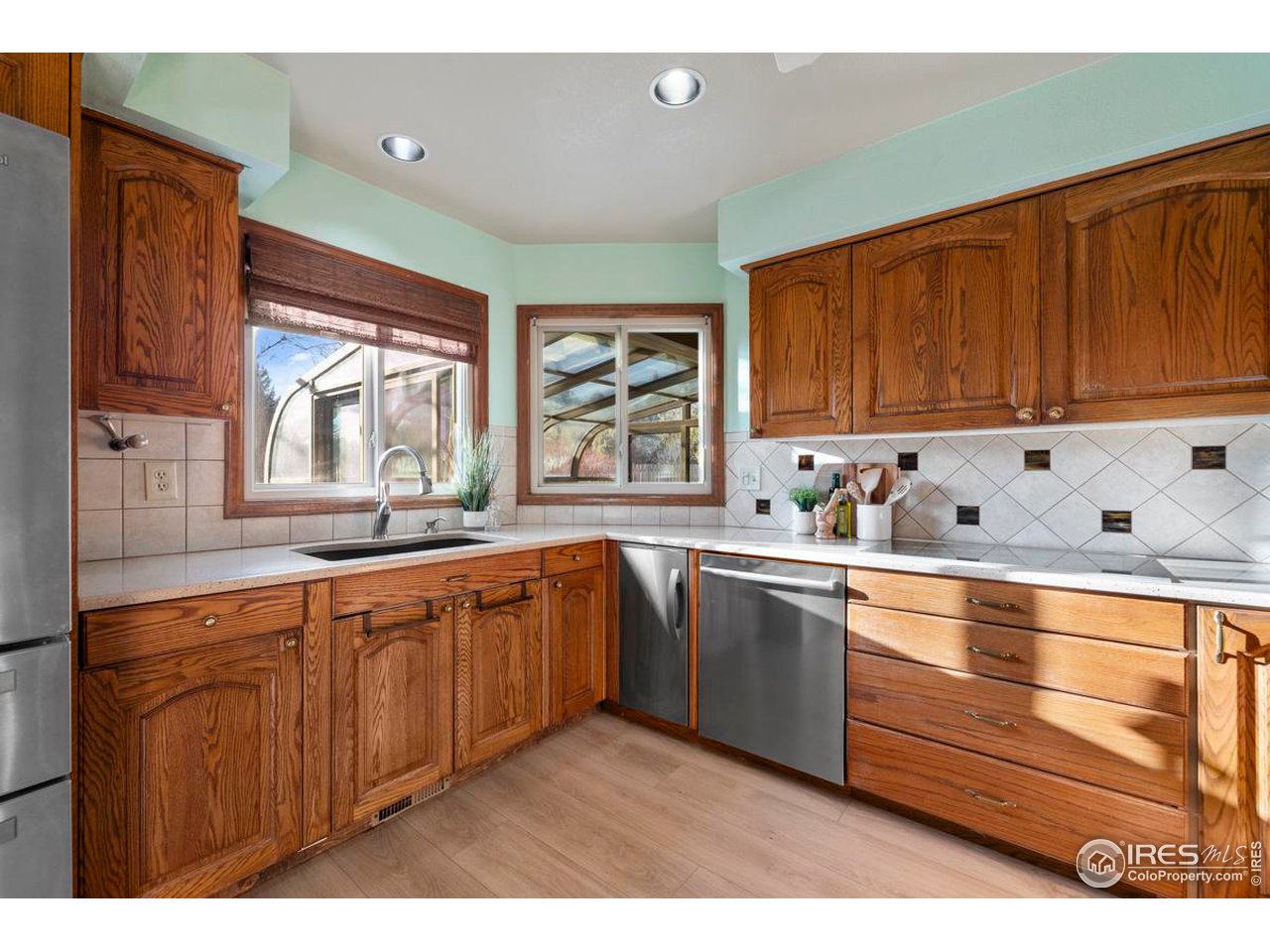 2713 Beech Way Longmont, CO 80503 - Photo 15 of 36 a kitchen with granite countertop wooden cabinets a sink and a window