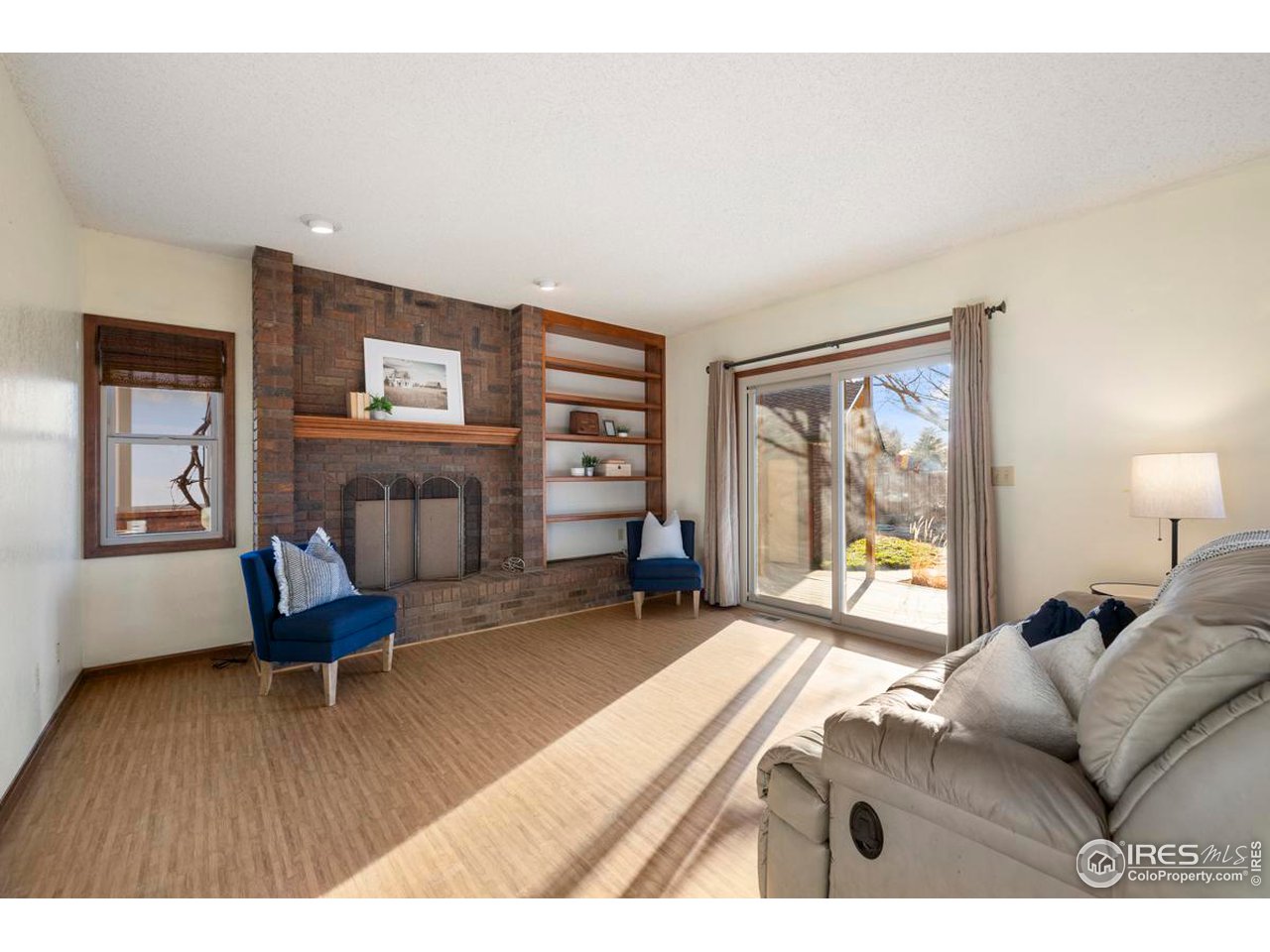 2713 Beech Way Longmont, CO 80503 - Photo 17 of 36 a living room with furniture and a fireplace