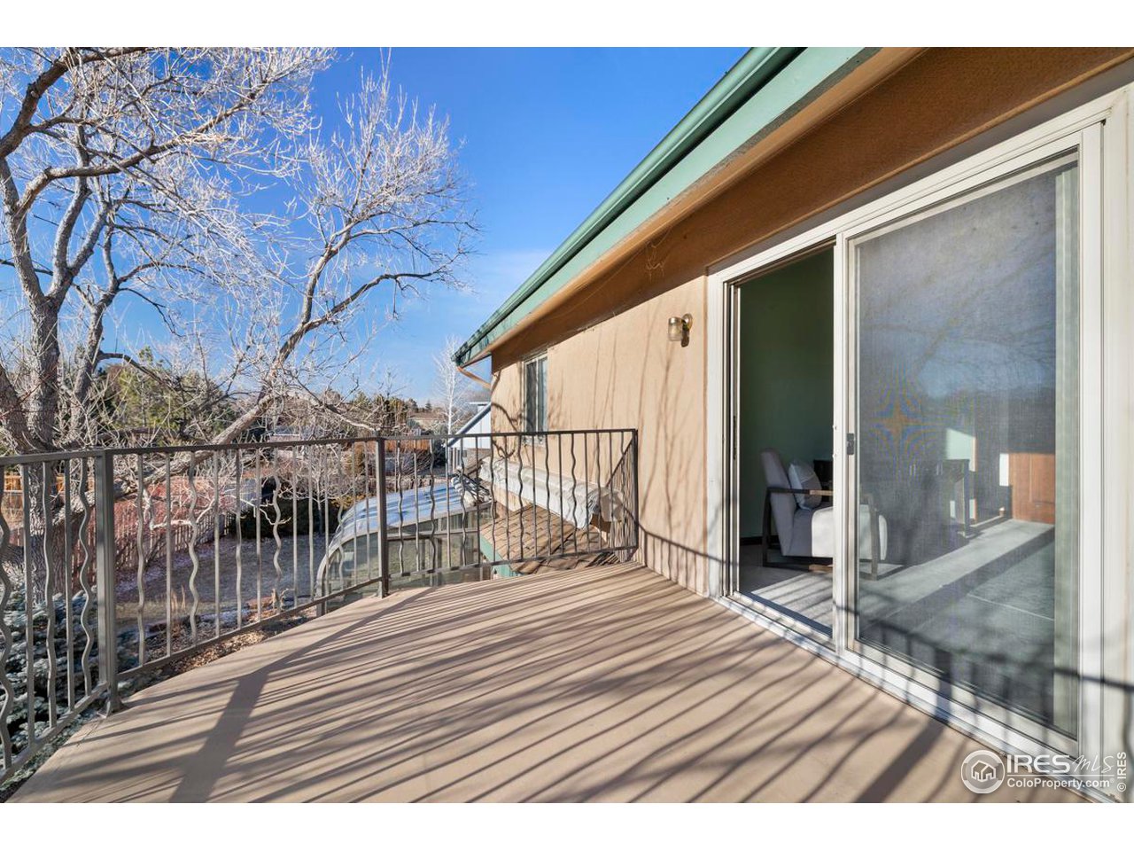 2713 Beech Way Longmont, CO 80503 - Photo 24 of 36 a view of a balcony with wooden floor and floor to ceiling window