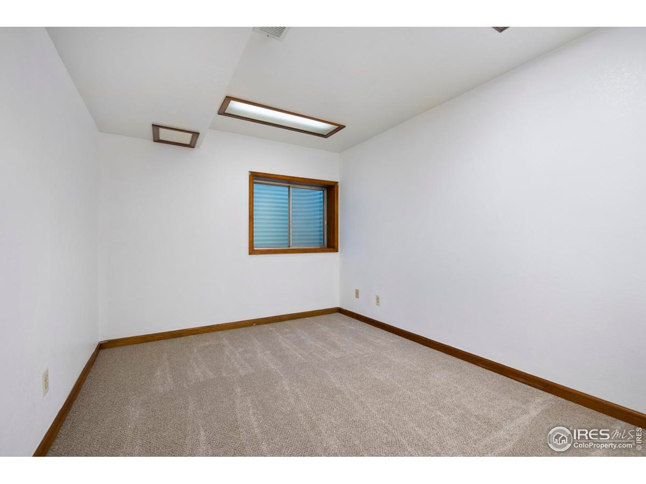 2713 Beech Way Longmont, CO 80503 - Photo 29 of 36 a view of an empty room with wooden floor and a window