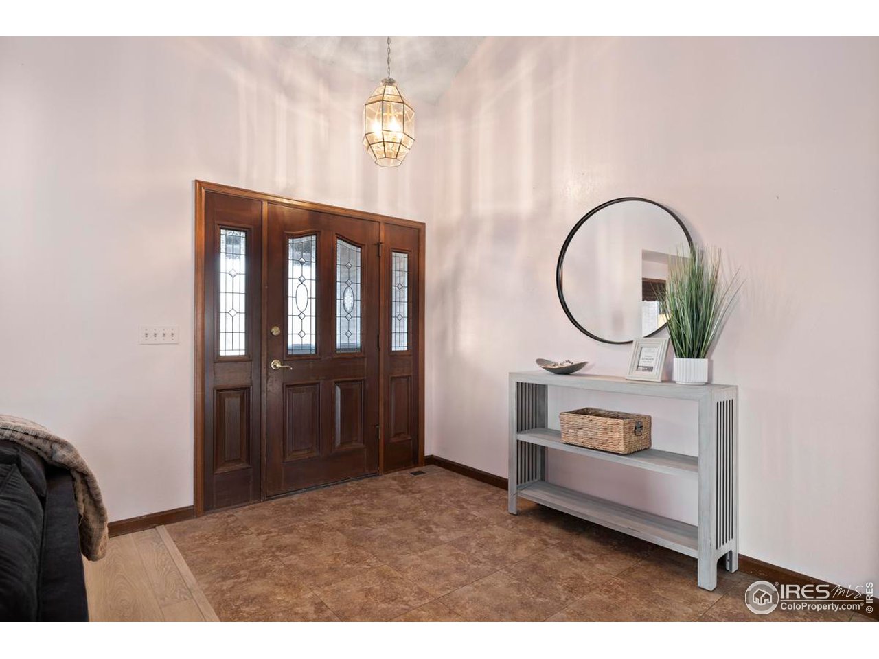 2713 Beech Way Longmont, CO 80503 - Photo 5 of 36 a living room with furniture a mirror and a wooden floor